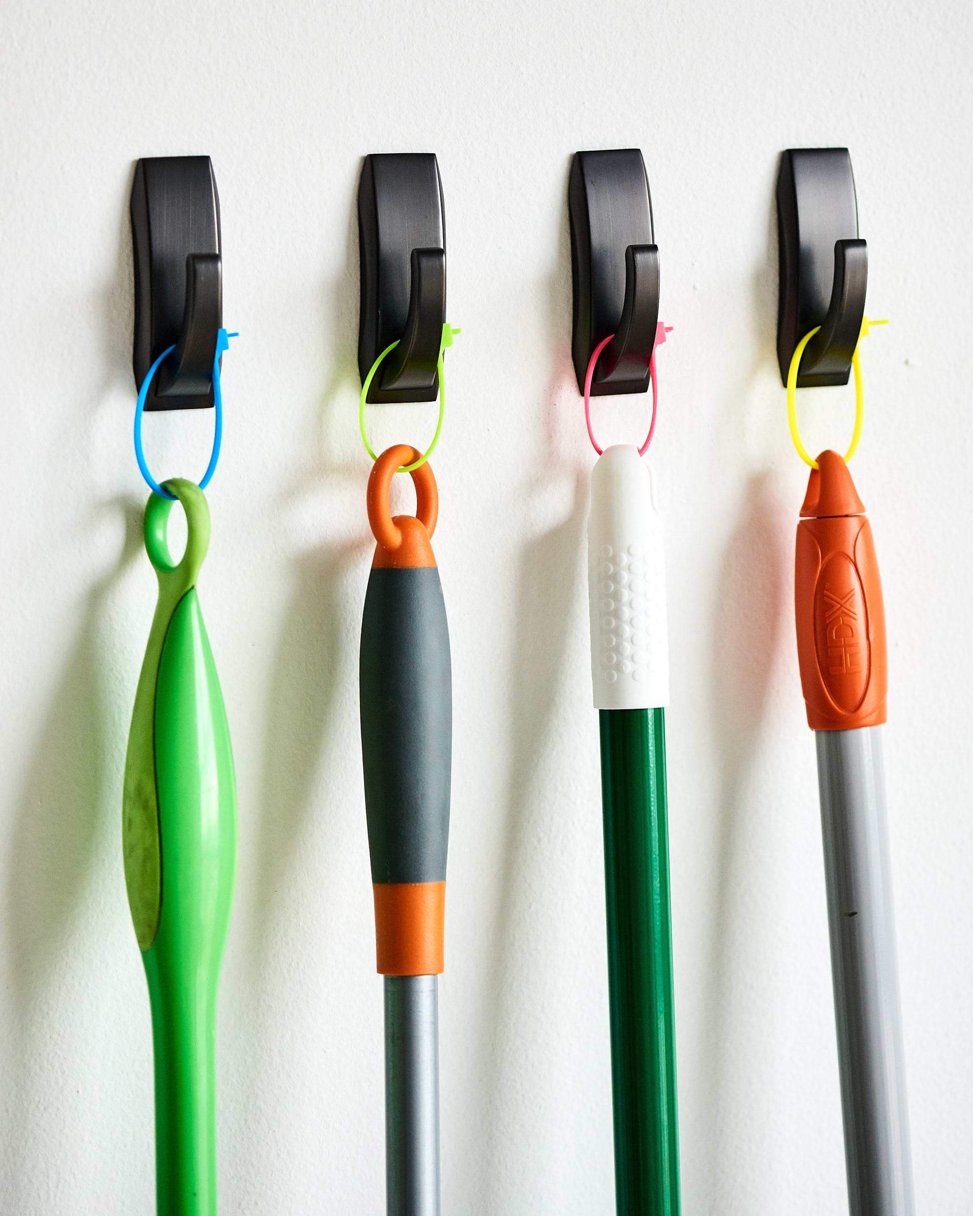 Try This Zip Tie Broom and Mop Storage Idea