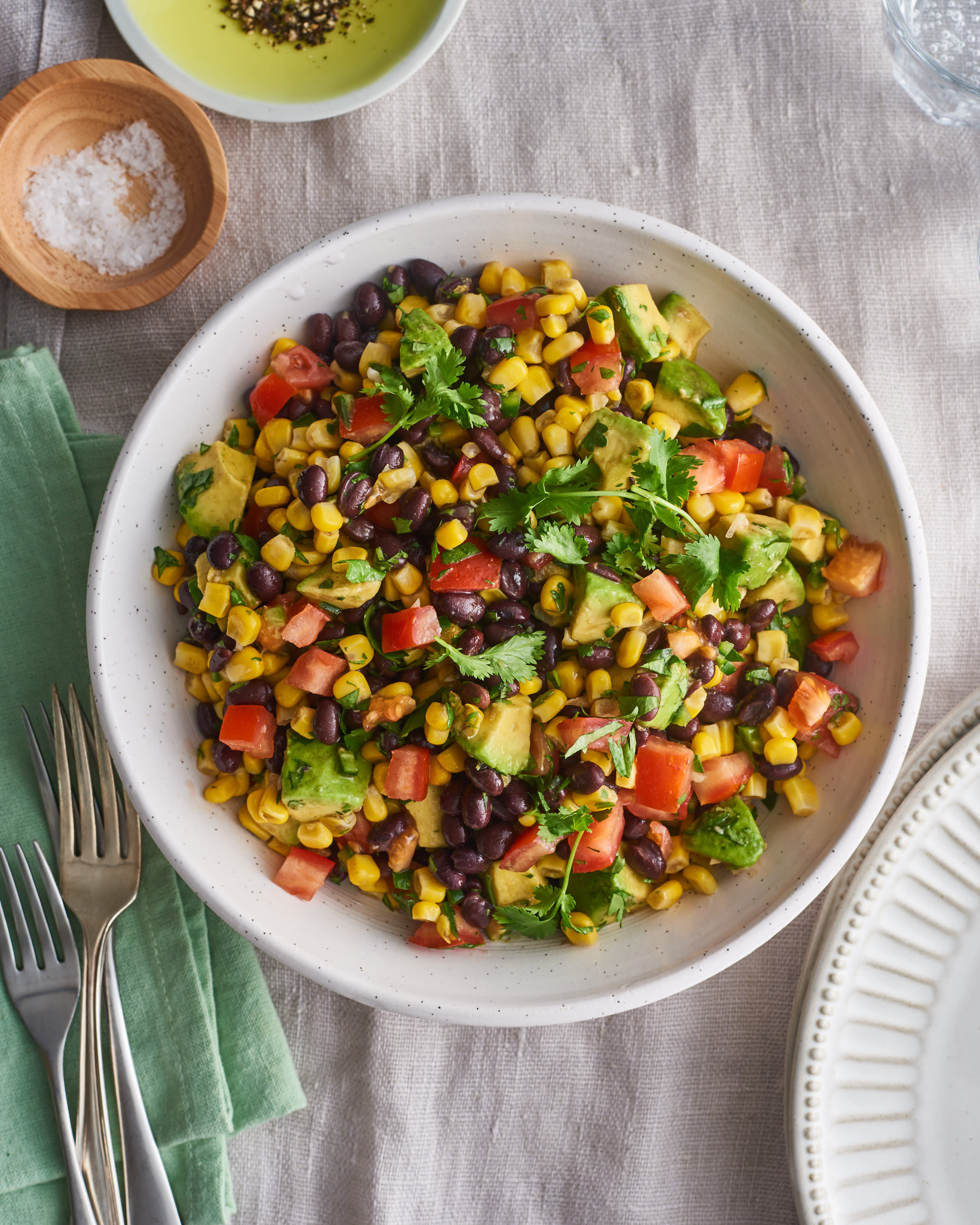 salad bowl with beans, avocado, tomato and sour cream