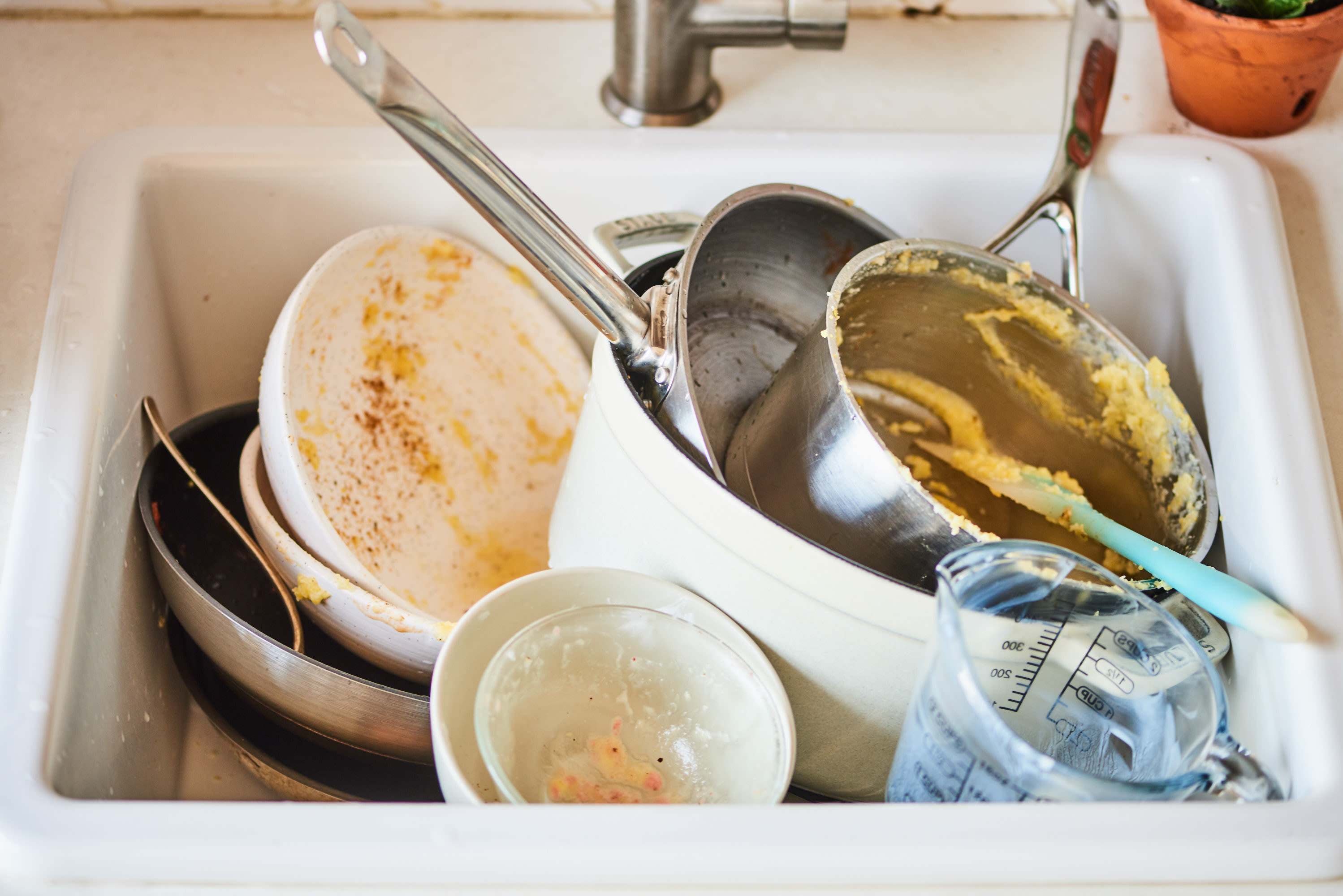 The Worst Thing You Can Do When Washing Greasy Pans, According to a Plumber