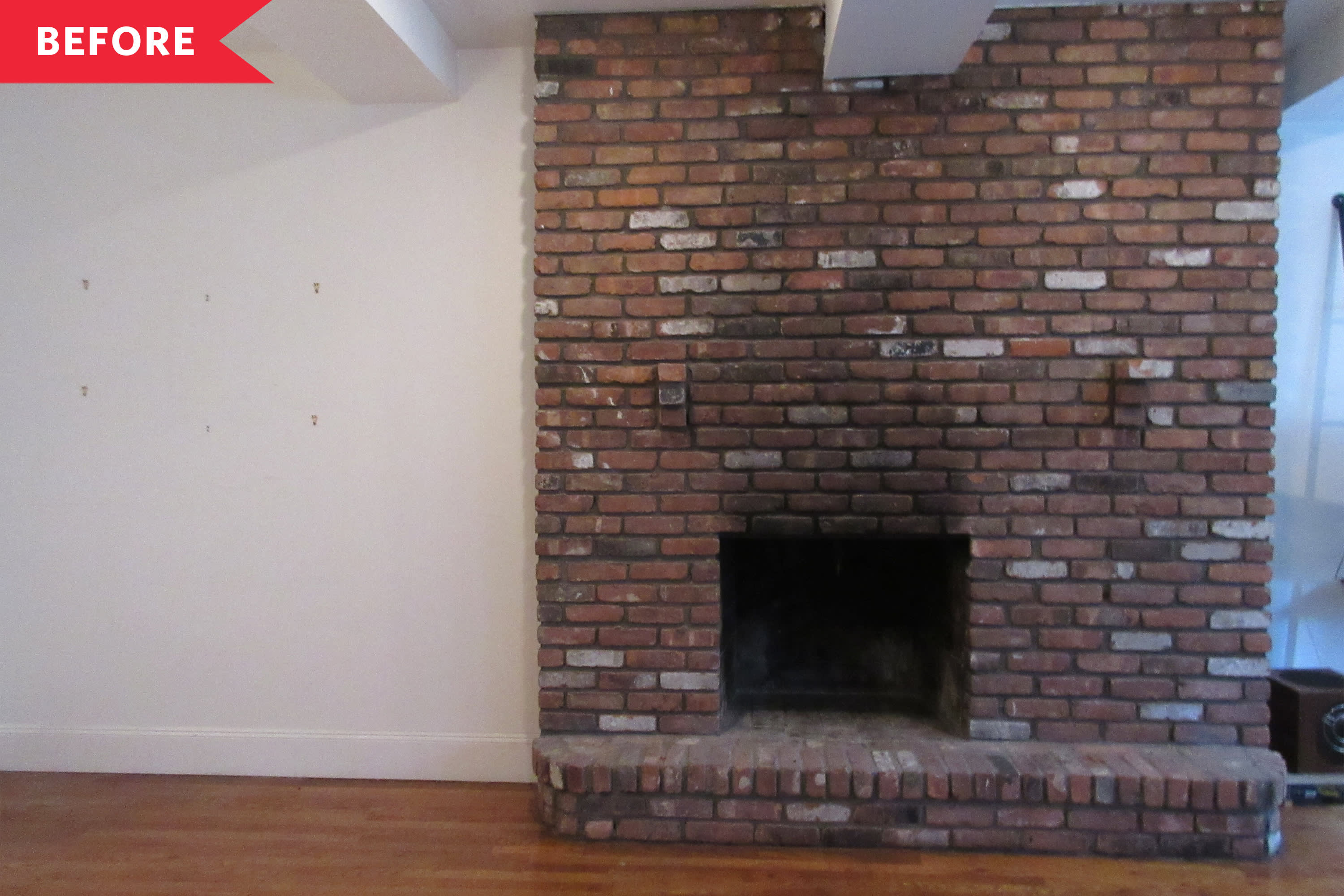 Wood stove in traditional brick fireplace