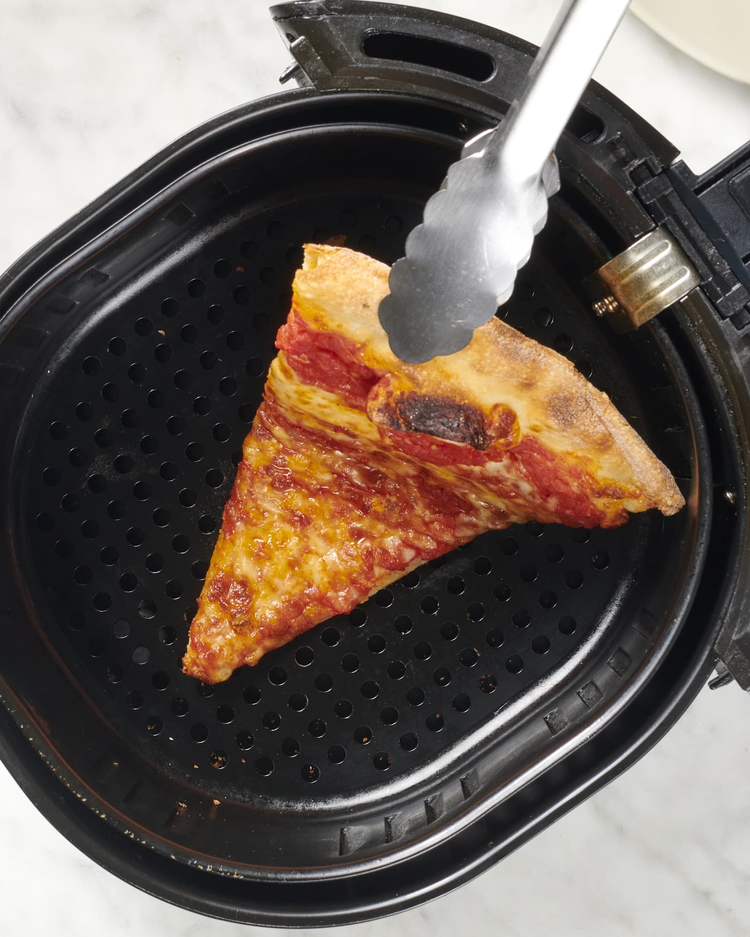 https://cdn.apartmenttherapy.info/image/upload/v1694807899/k/Photo/Series/2023-09-how-to-reheat-pizza-in-an-airfryer/cropped/how-to-reheat-pizza-in-an-air-fryer-082.-01g.jpg