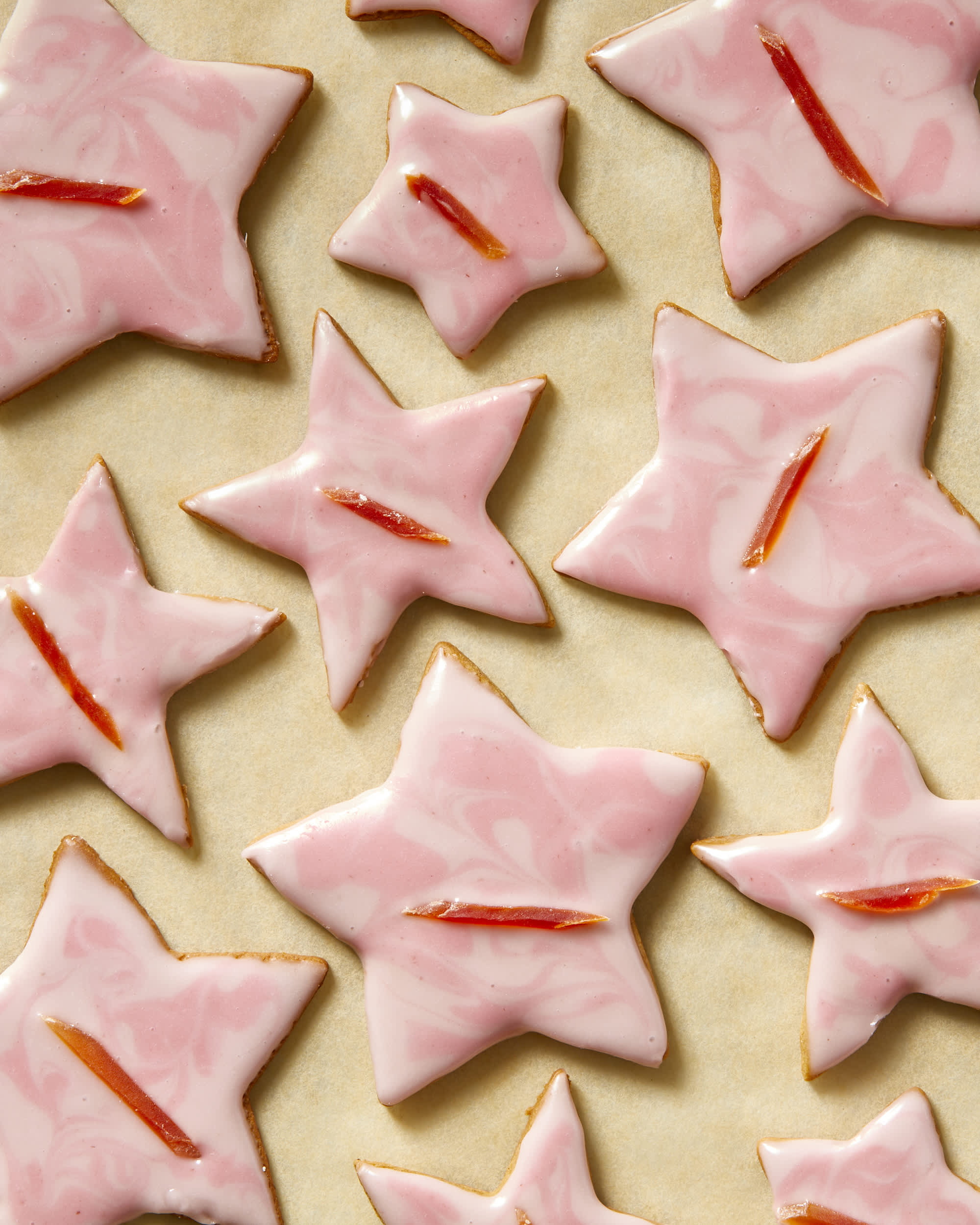 Gingerbread cookies as stars shape for Christmas, on a parchment