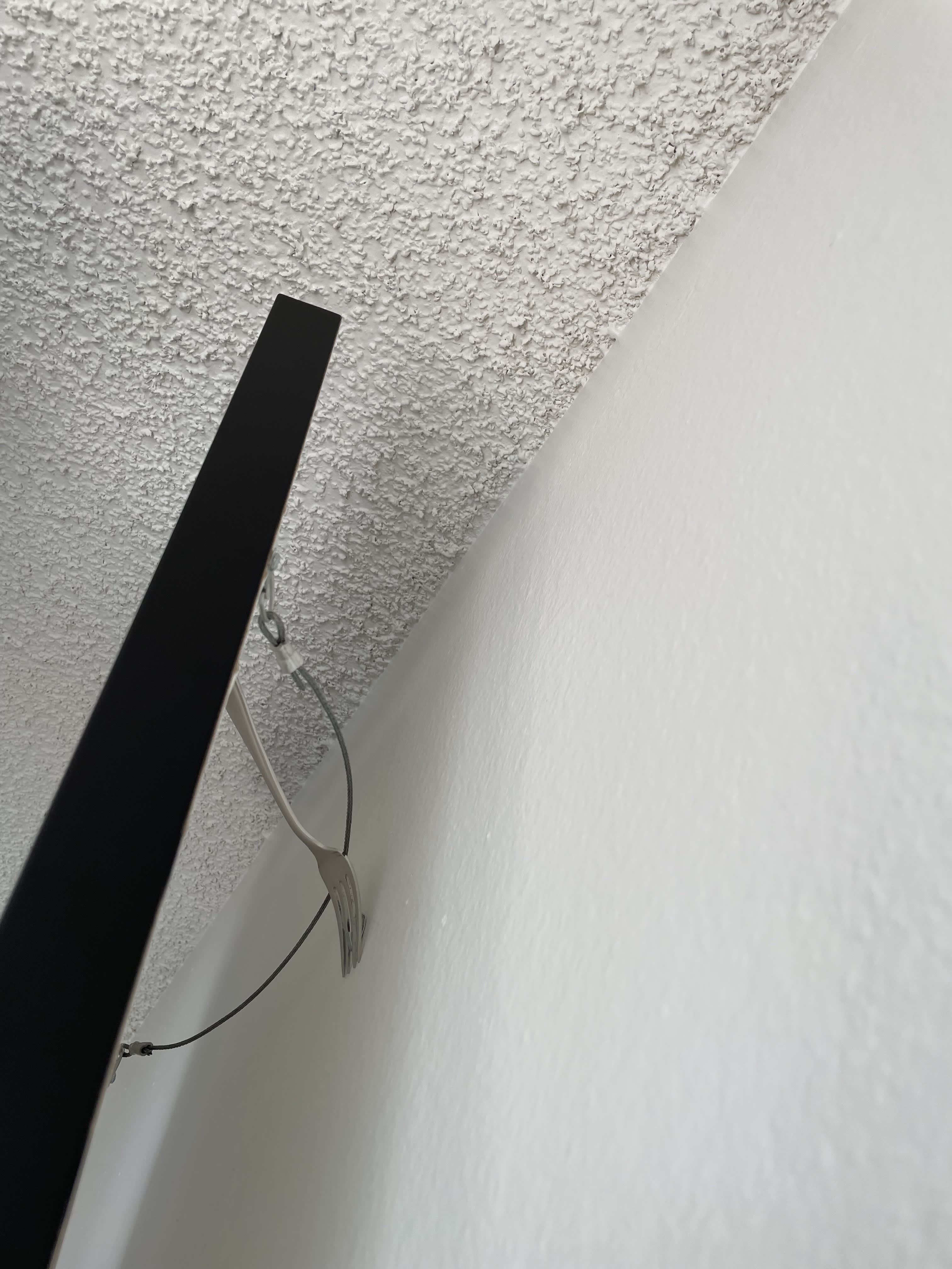 Try This Super Easy Hack for Hanging Pictures With a Fork