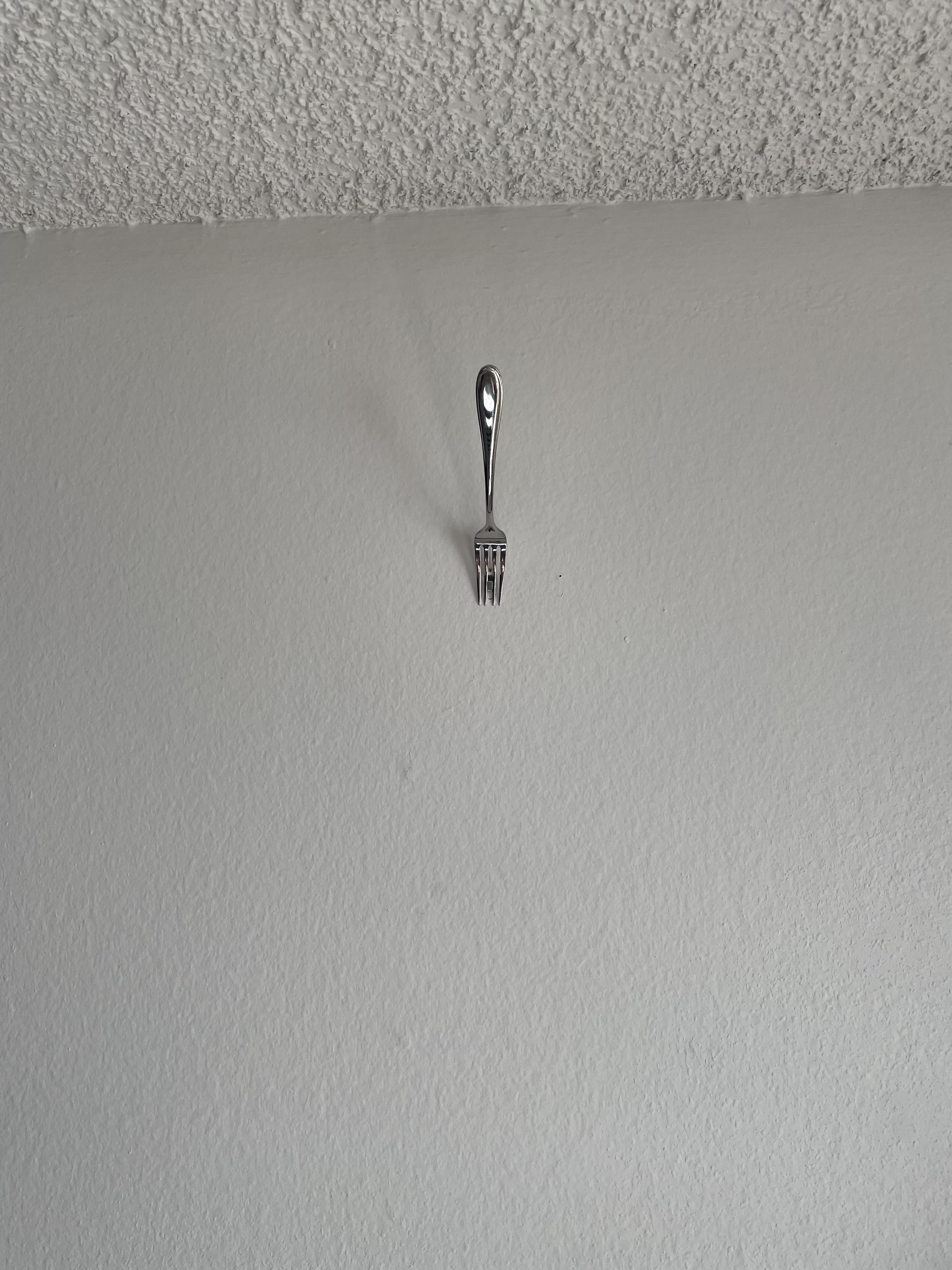 Try This Super Easy Hack for Hanging Pictures With a Fork