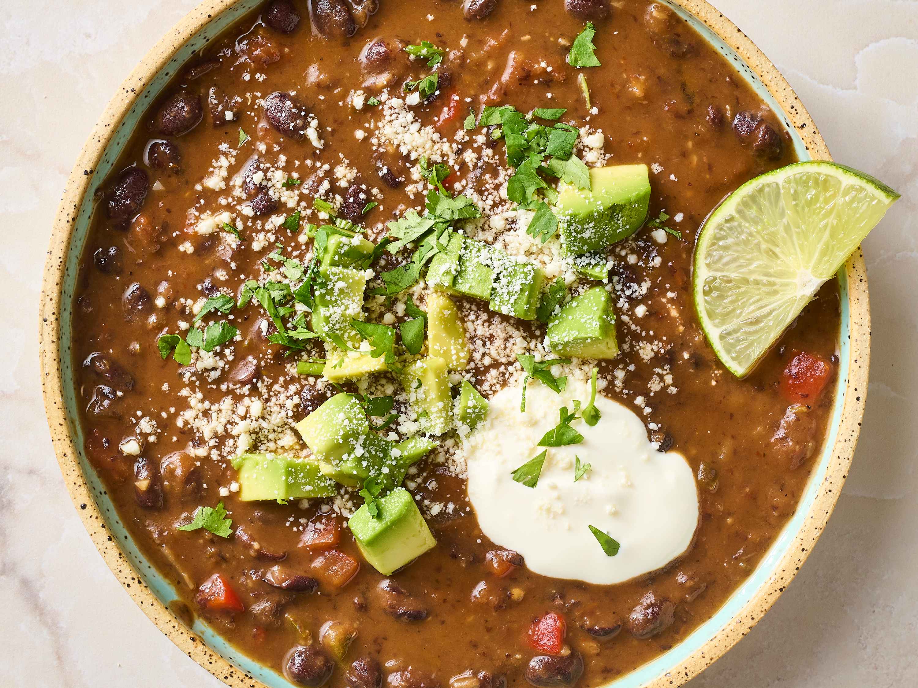 Spicy black bean soup with toppings