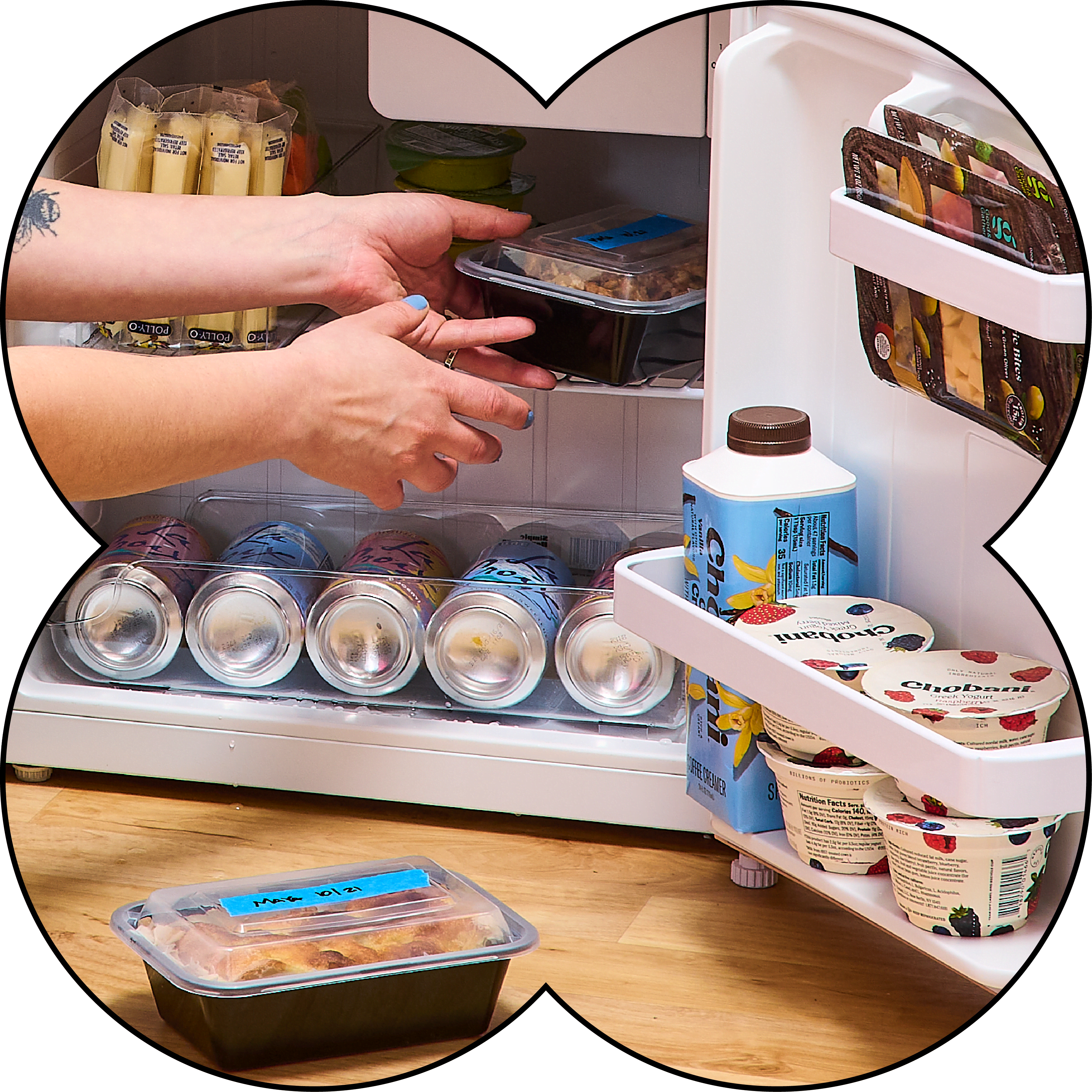 Person putting away food in fridge